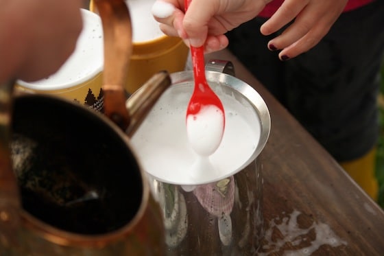 child with plastic spoon and soap foam