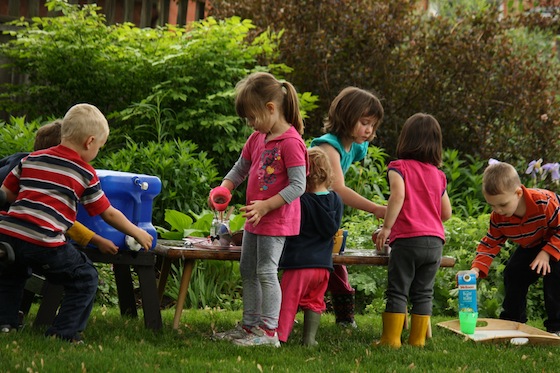 kids playing pretend coffee shop in backyard