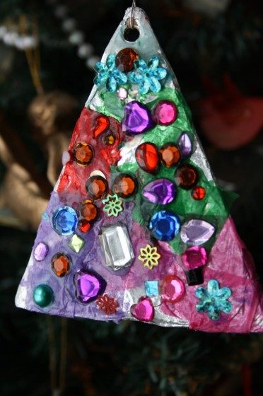 cardboard triangle covered with tin foil, tissue paper and craft gems