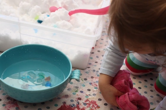 drying hands while playing with the snow sensory bin