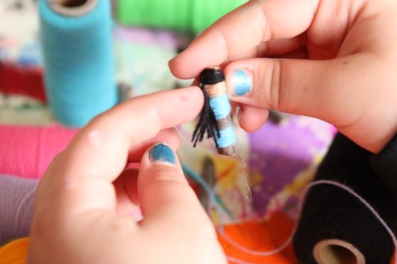 Child making a worry doll with hair