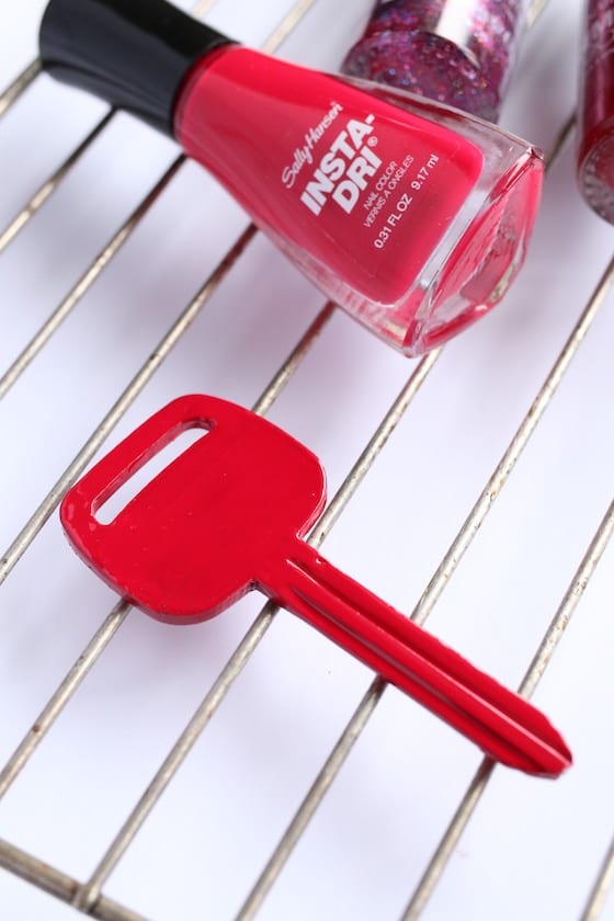 Homemade Santa key painted red drying on baking rack