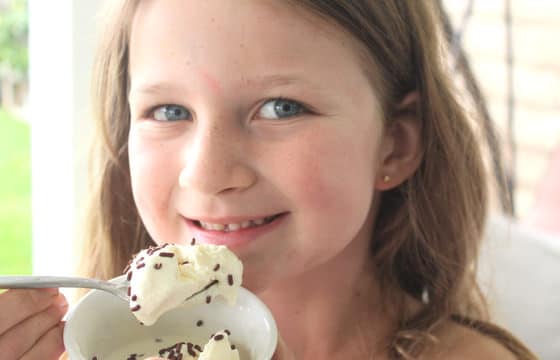 girl eating ice spoonful of homemade vanilla ice cream