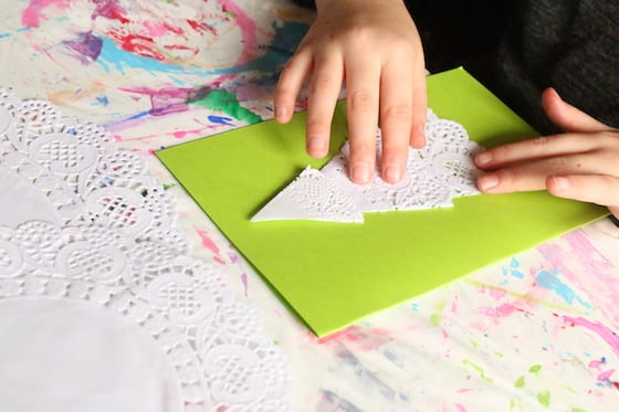 kid making doily christmas card