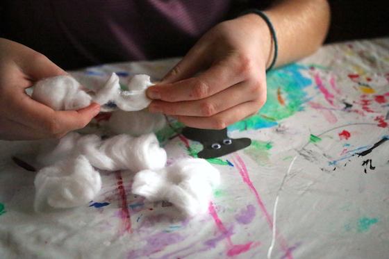 kid pulling apart cotton balls