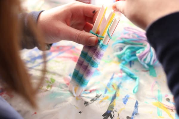 kid weaving on 3 straws