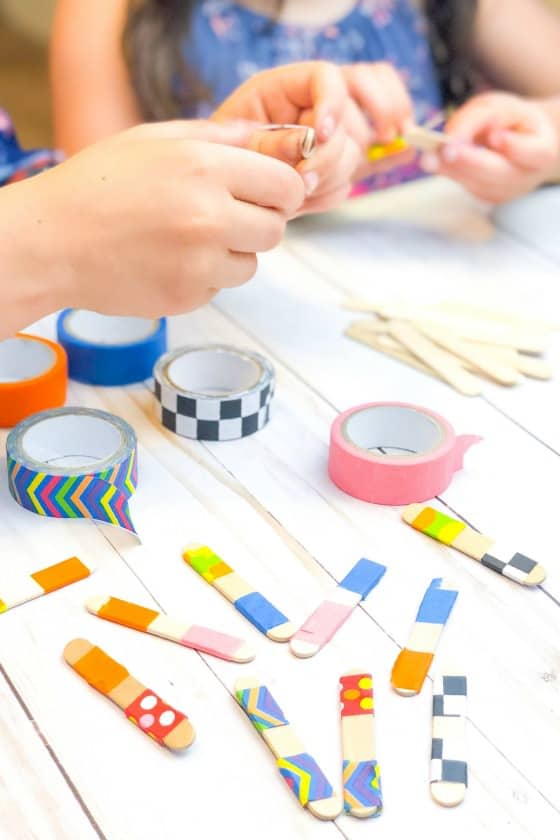 kids making homemade dominoes from craft sticks