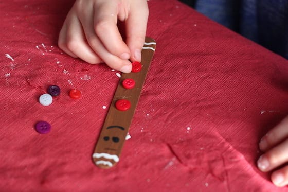 kids making popsicle stick gingerbread ornaments