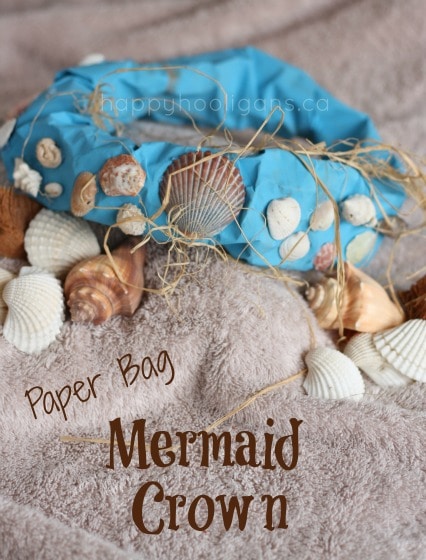 paper bag mermaid crown sitting on a bed of shells