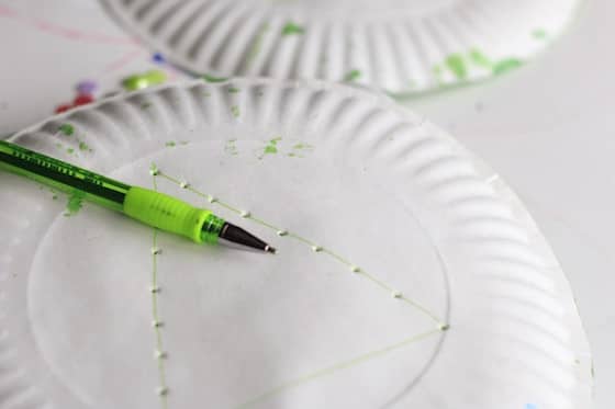 poking holes in a paper plate