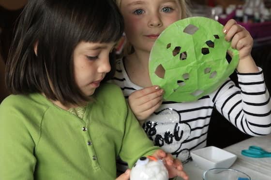 kids making snowflakes out of painted coffee filters