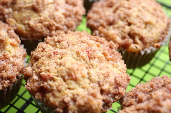 6 Muffins made with Rhubarb and homemade buttermilk on black rack on green cutting mat