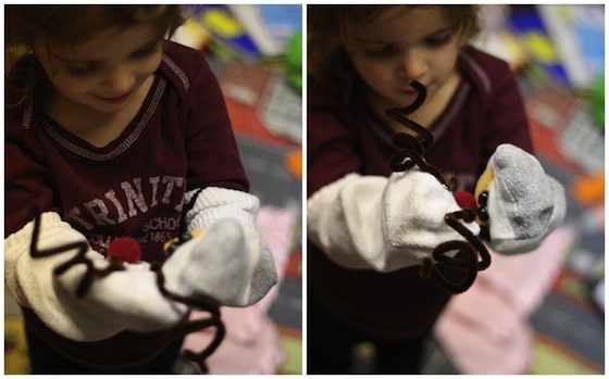 child playing with homemade christmas sock puppets