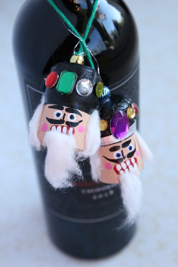 nutcracker Christmas ornament around neck of bottle of wine