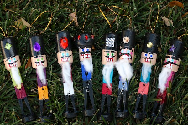 clothespin nutcrackers lined up in grass