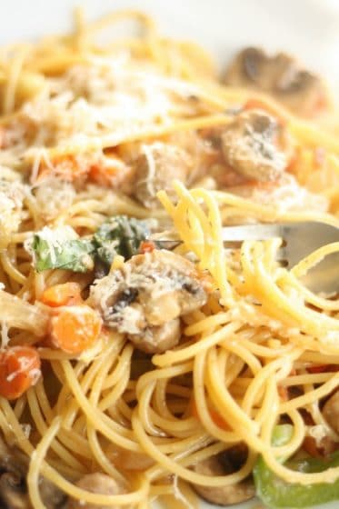 Close up spaghetti with mushroom, basil and parmesan cheese