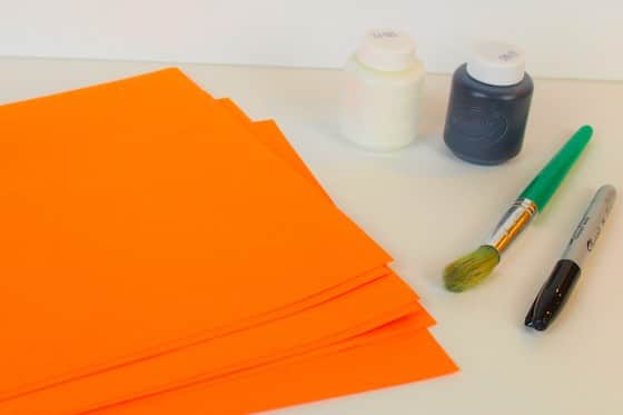 Orange contstruction paper with white and black paint