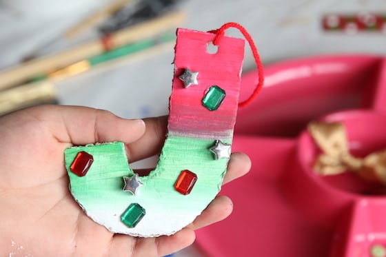 Cardboard J ornament - ombre green and red with craft jewels glued on