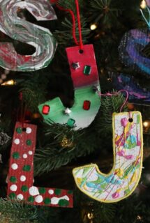 Painted cardboard letters on Christmas tree - feature image vertical