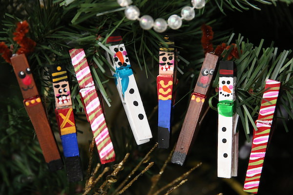 homemade clothespin ornaments hung in a row on christmas tree