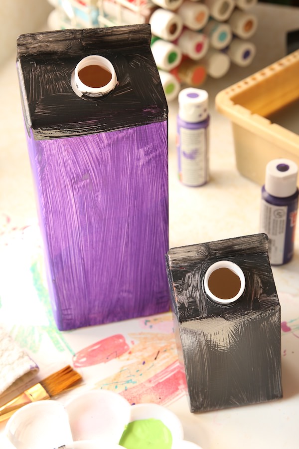 milk cartons painted black and purple