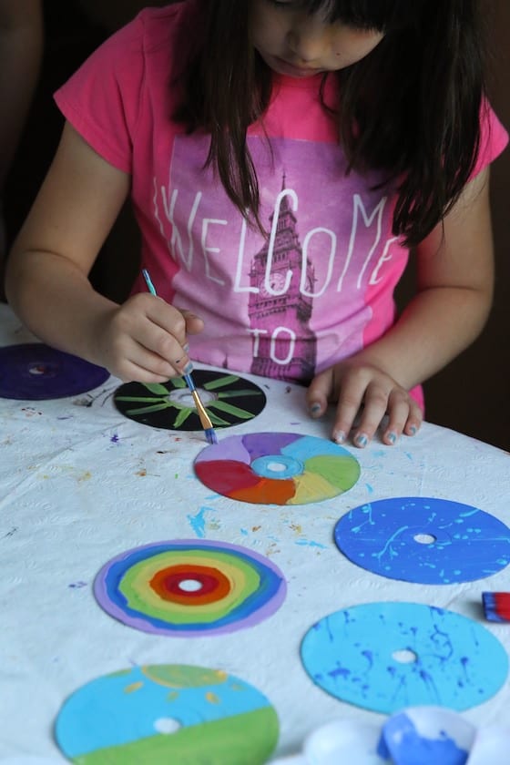 Child decorating CD to look like a colour wheel