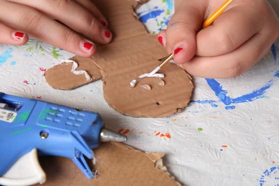 painting mouth on gingerbread man