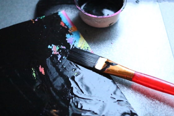 painting over crayons with black tempera paint