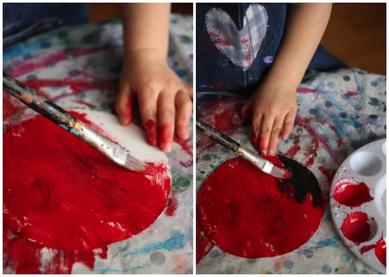 painting paper plates with red paint