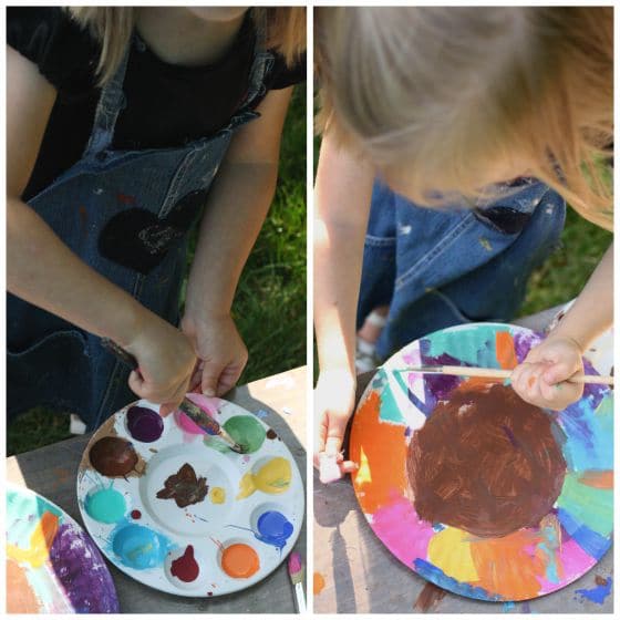 preschooler painting a paper plate