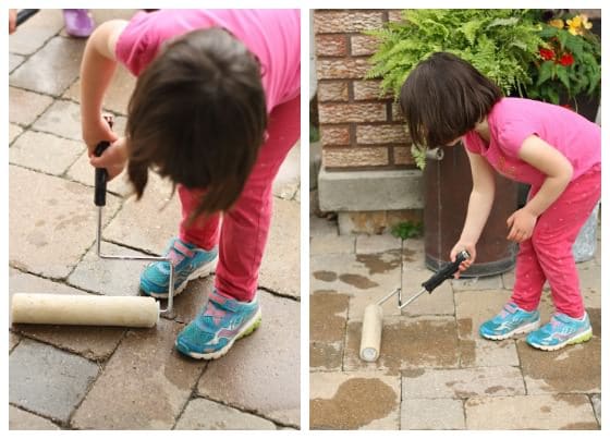 painting the sidewalk with paint rollers and water