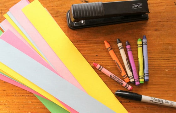 crayons, stapler, marker, paper strips