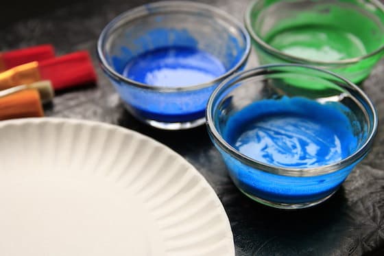 Paint brushes, Paper Plate and 3 bowls of Homemade Puffy Paints