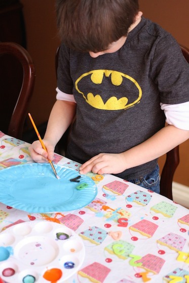 gluing foam numbers on a paper plate clock