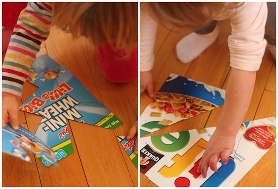 toddlers putting together homemade puzzles made from cereal boxes