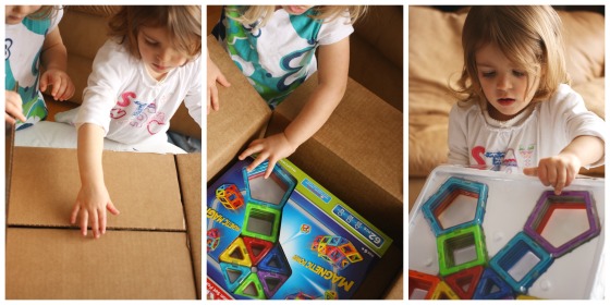 Toddlers opening a box of Magformers