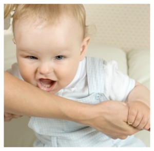 baby biting mom on the arm