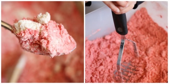 mixing coloured cloud dough with potato masher