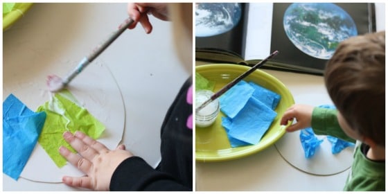 Kids gluing green and blue tissue paper to cardboard circle