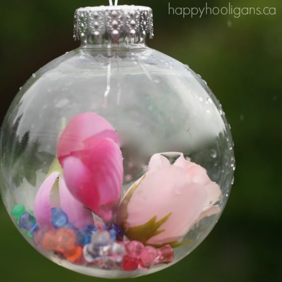 pink flowers and beads dropped into clear plastic ornament