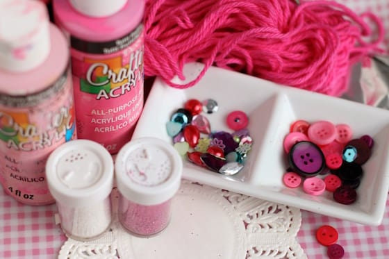 pink paint, glitter, pink yarn, doilies, red and purple buttons