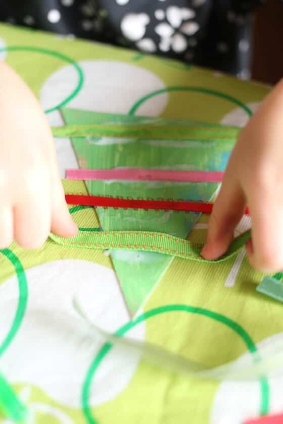 placing ribbon across Christmas tree ornament