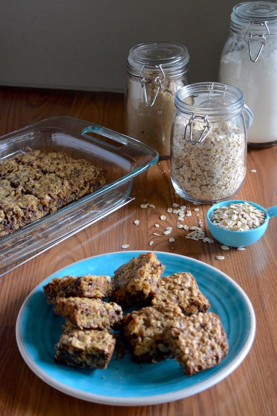 plate of oatmeal chocolate chip squares and jar of oats