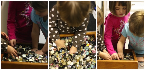 playing in a box of buttons