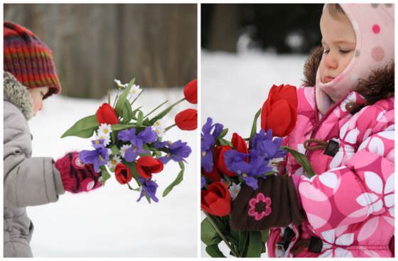 Playing with artificial flowers in the yard in winter