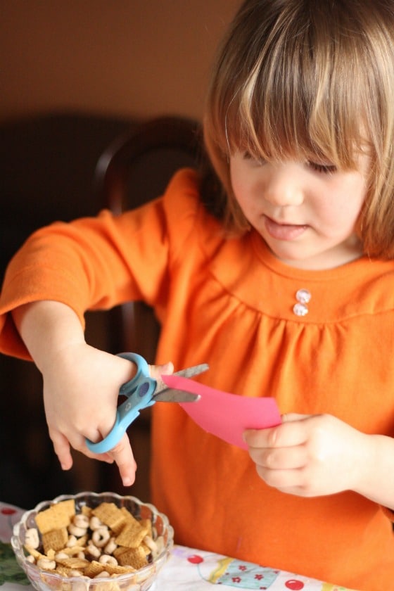 Preschooler cutting paper circles out of card stock