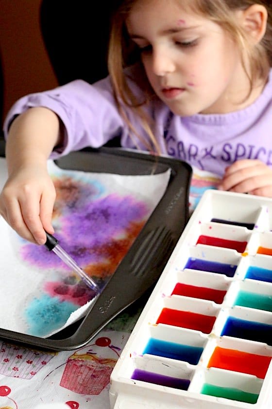 Preschooler making drip art with liquid watercolours