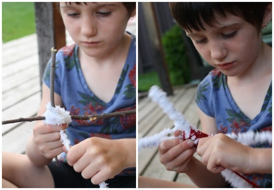 preschooler weaving yarn around twigs