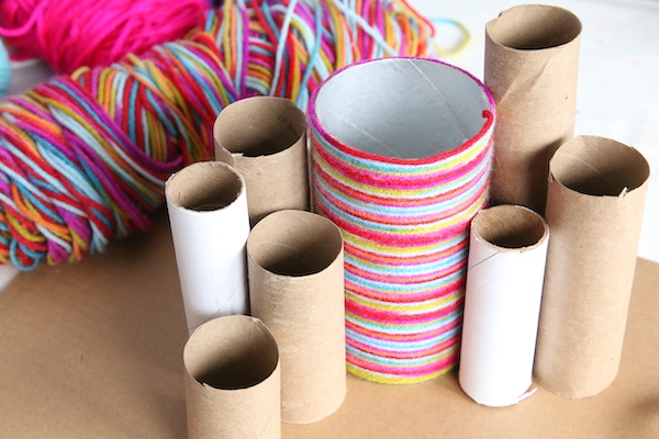 arrangement of Pringles can and toilet rolls