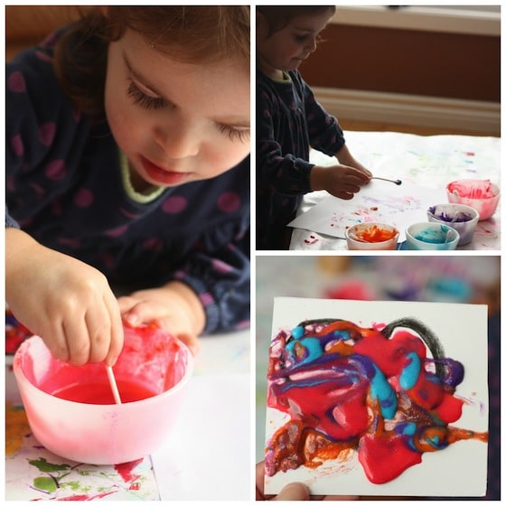 Child paints Valentines hearts with home-made puffy paint.